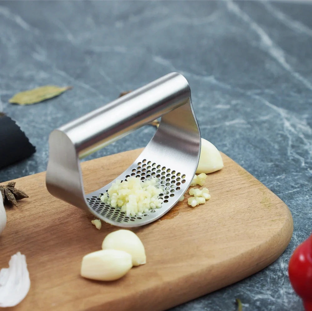 Stainless steel garlic press with uniform mincing holes measuring 10.5cm in length