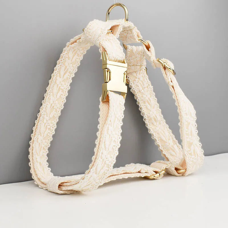 White lace dog vest and matching collar with floral decoration for wedding or special occasion.