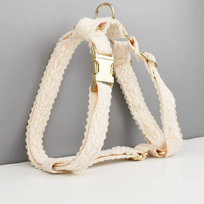 White lace dog vest and matching collar with floral decoration for wedding or special occasion.