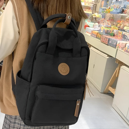 Black Oxford cloth fashion backpack with curved shoulder straps and retro sewing details