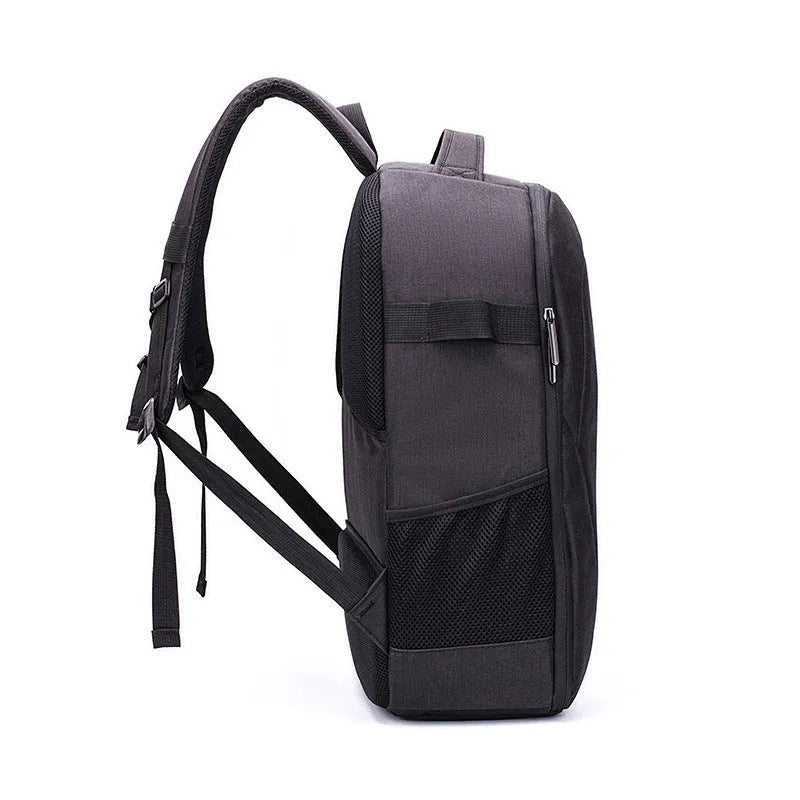 Black Oxford cloth waterproof backpack open to show internal camera, laptop, and organiser pockets