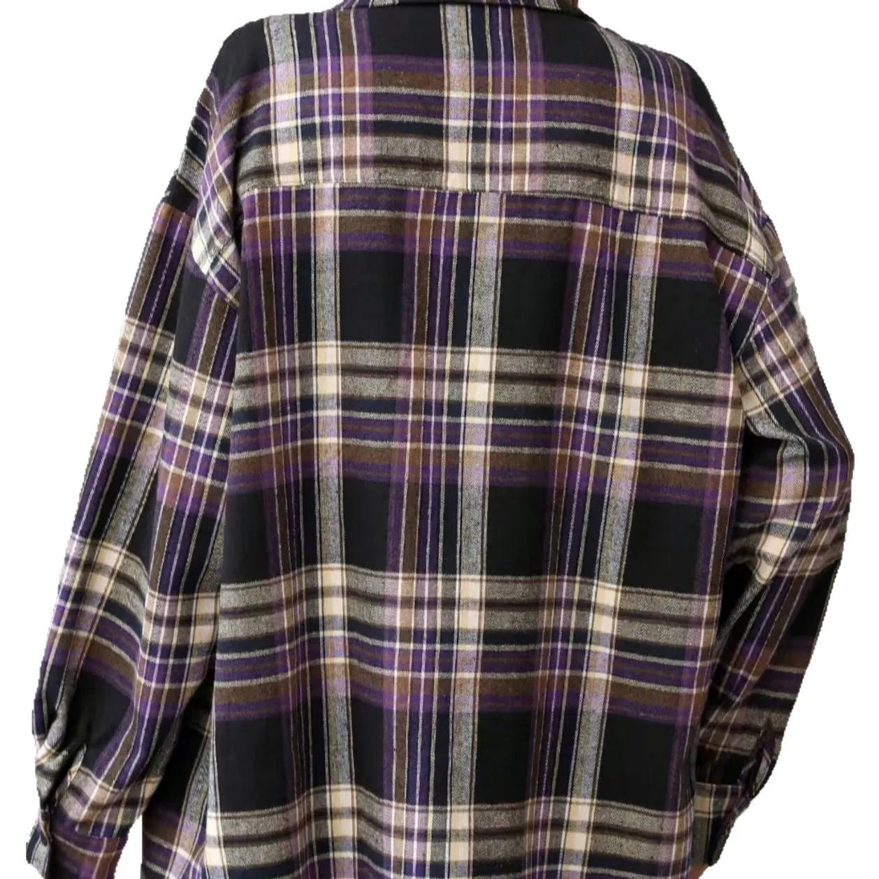 A woman modelling a loose-fit black, green, and purple plaid shirt with long sleeves.