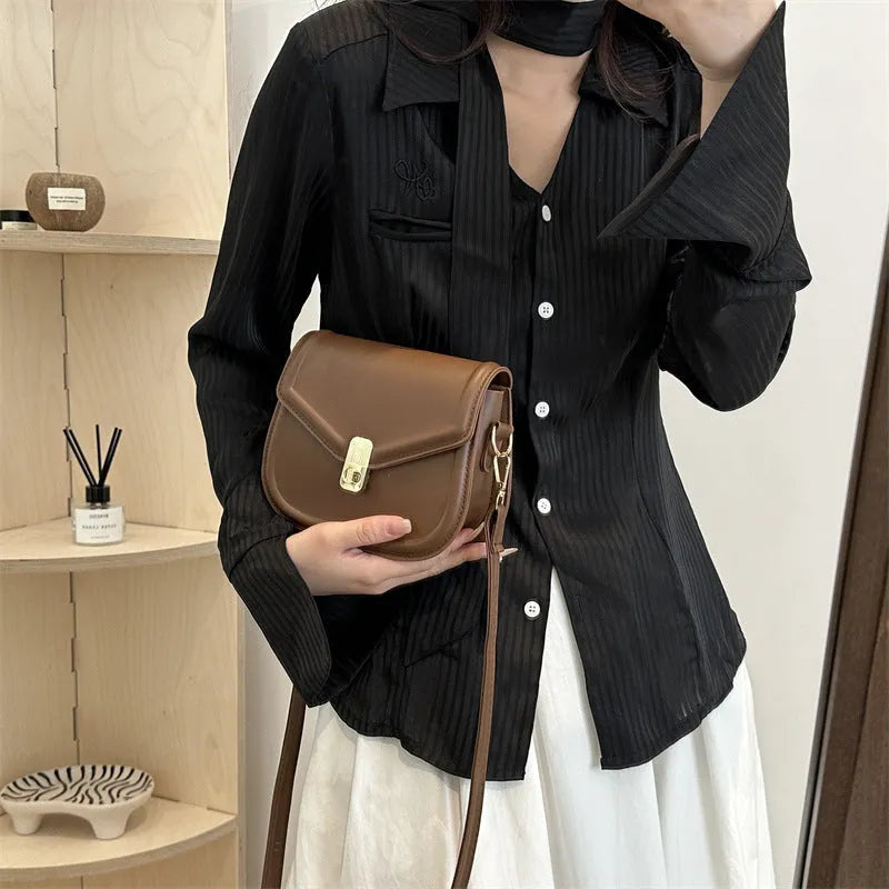 Soft PU leather messenger bag with clamshell opening in black, dark brown, khaki or white.