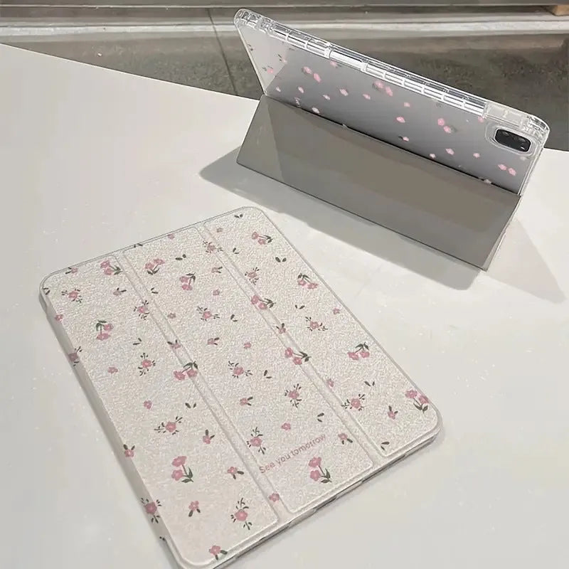 Transparent tri-fold iPad case with floral design, showing magnetic front cover and rear kickstand deployed.