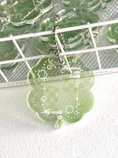 Blue, green, and mint green four-leaf clover acrylic pendant keychain on a metal ring.