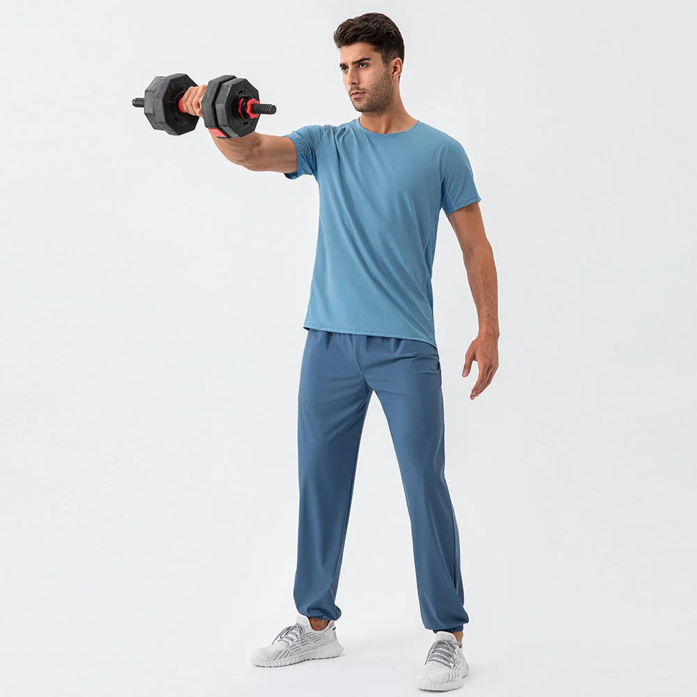 Men's lightweight nylon track pants in various colors, featuring a relaxed, flexible fit for active lifestyles