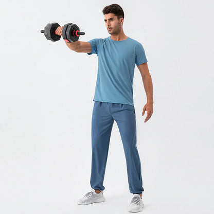 Men's lightweight nylon track pants in various colors, featuring a relaxed, flexible fit for active lifestyles