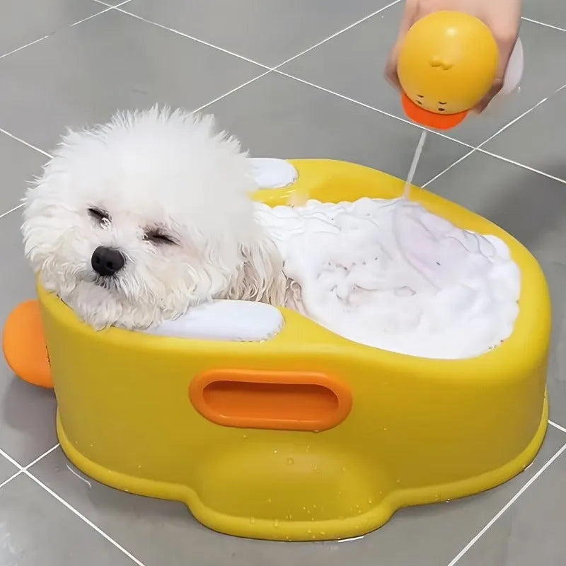 Blue PVC duck-shaped bathtub for washing a small dog or cat outdoors.
