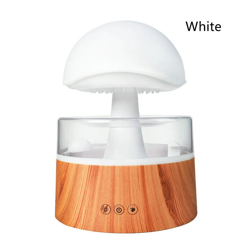 White rain cloud humidifier with falling water droplets and coloured LED lights on nightstand