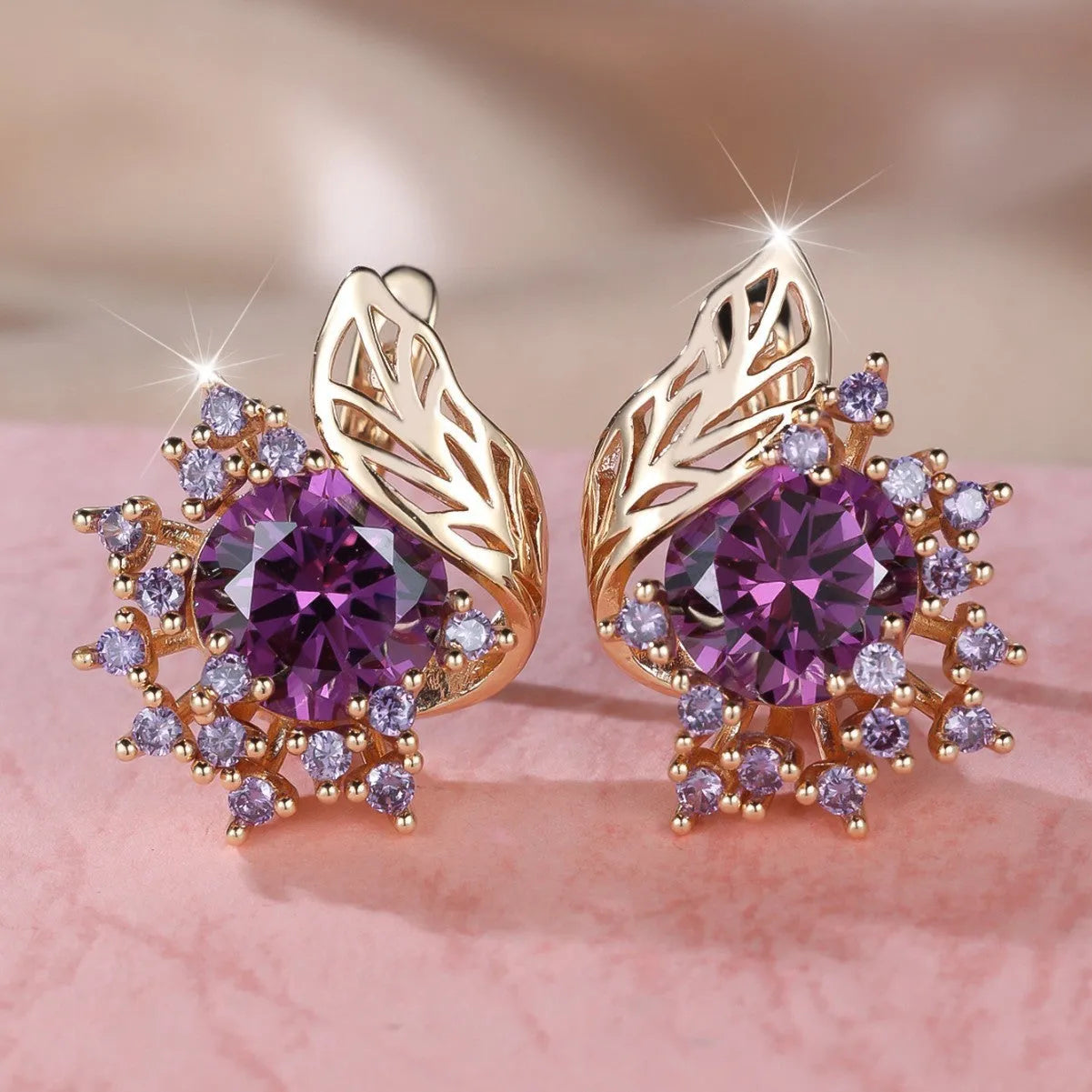Round flower and feather design earrings in champagne gold with a choice of coloured zircon stones.