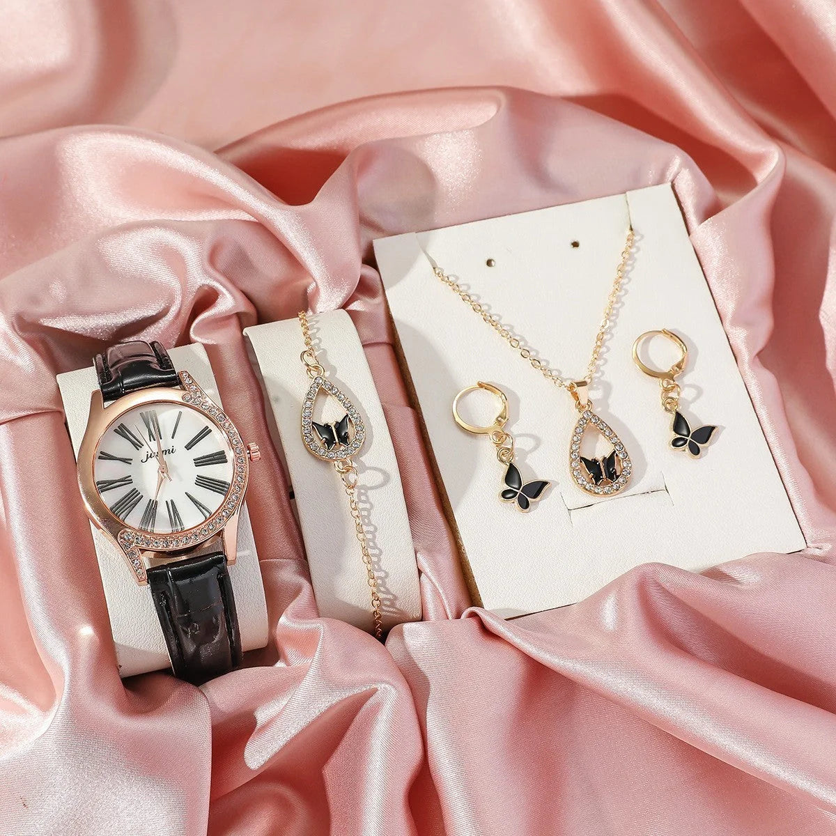 Elegant butterfly jewelry set including necklace, bracelet, and earrings with intricate design in various color options