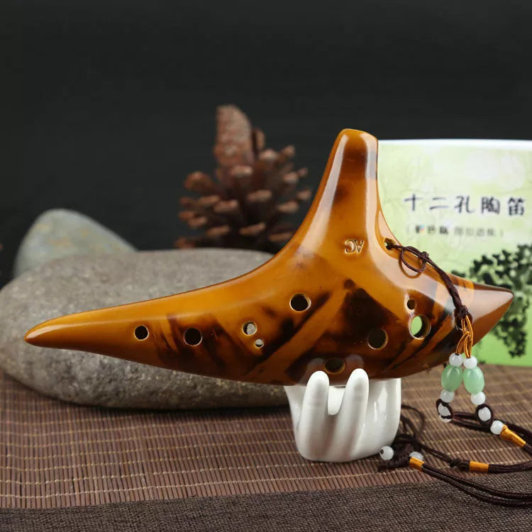 Ceramic 12-hole smoldering ocarina in alto C pitch with nest-inspired design