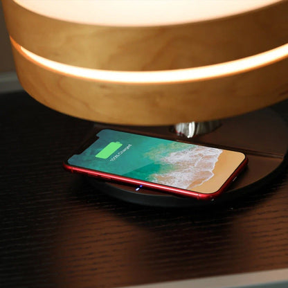 Round Bluetooth speaker with LED tree lighting and wireless charging surface in maple brown finish