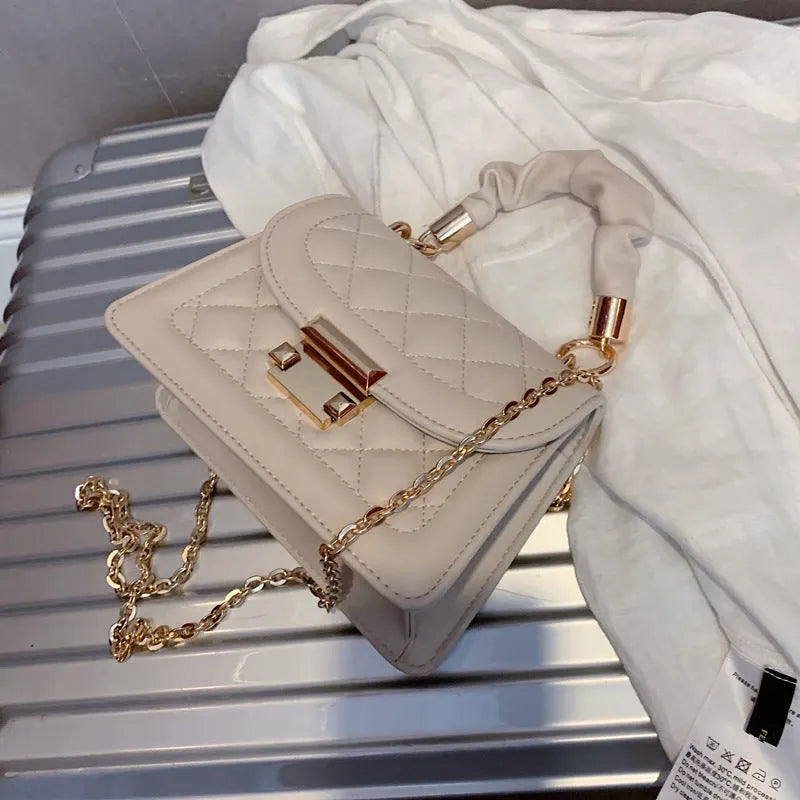 Beige rhombus-shaped women's crossbody bag with a long strap, showing front view and size.