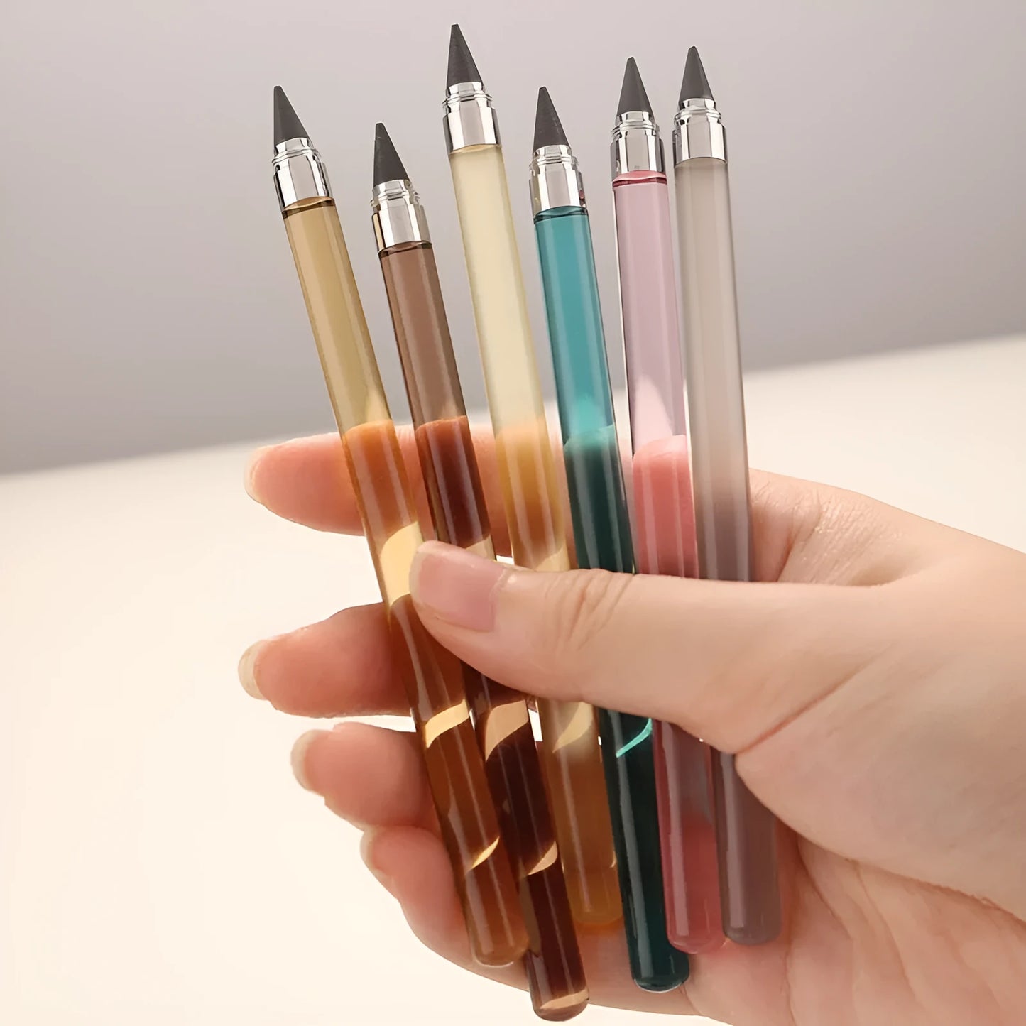 Transparent acrylic barrel mechanical pencil with alloy nib showing internal graphite lead