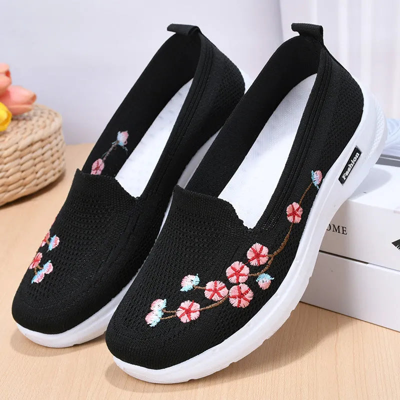 Women's low-top embroidered fly knit sports pumps in wine red with anti-slip sole.