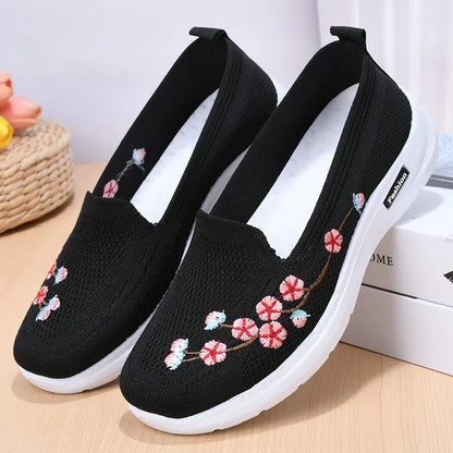 Women's low-top embroidered fly knit sports pumps in wine red with anti-slip sole.