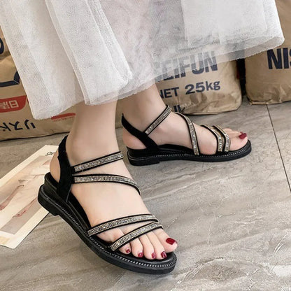 Women's silver sandals with elastic band and sequin accents, showing rubber sole and round toe design