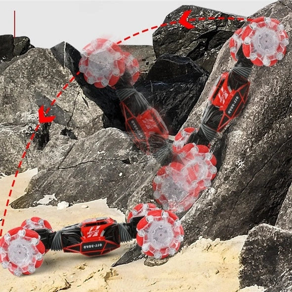 Red 4WD RC stunt car performing sideways drift with LED lights illuminated, showing gesture remote control