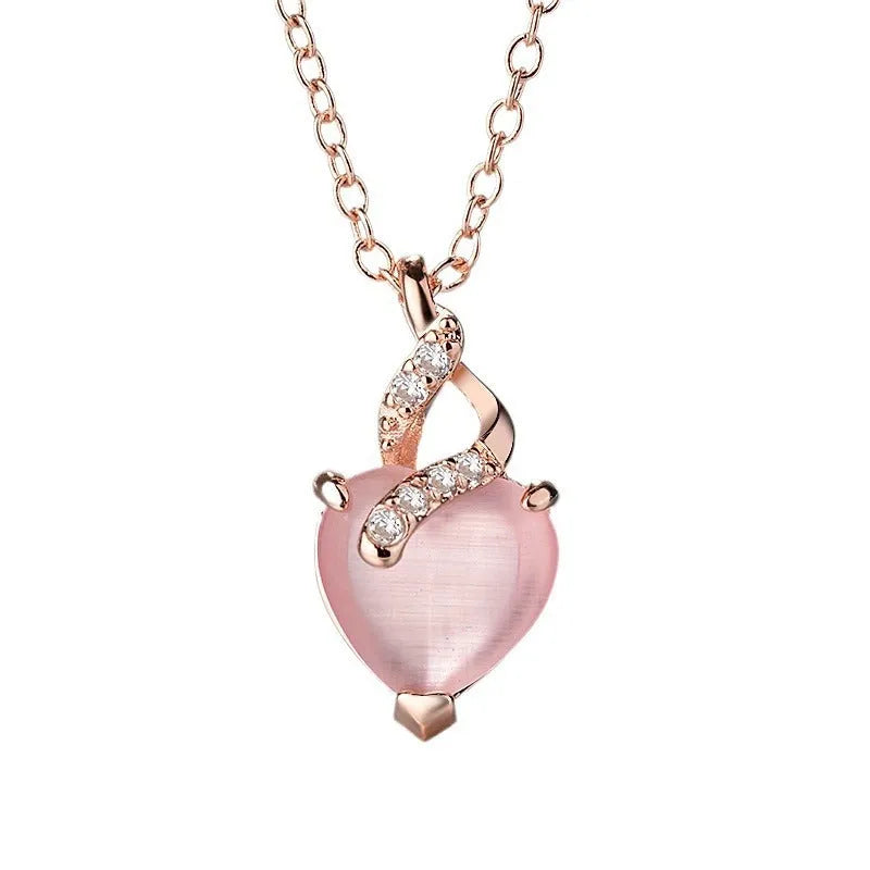 Women's heart-shaped pink crystal pendant necklace with rose gold finish and cross chain