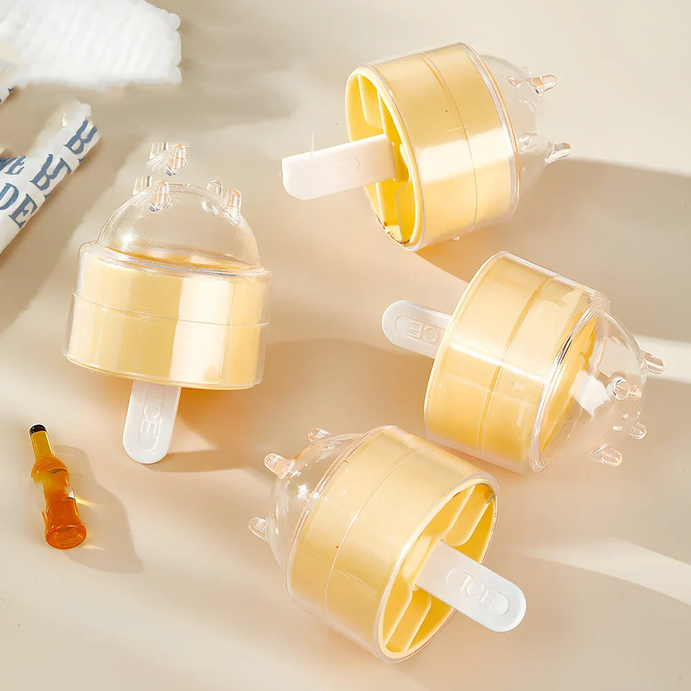 Four colourful lollipop-shaped silicone ice moulds showing creamy yellow, pink, blue, and yellow options