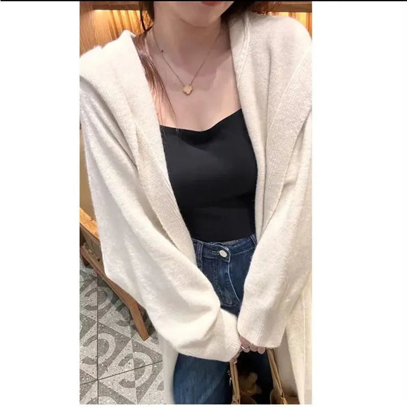 Women's Korean style hooded long knitted cardigan in oatmeal colour, showing loose fit and below-the-knee length