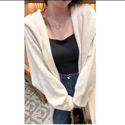 Women's Korean style hooded long knitted cardigan in oatmeal colour, showing loose fit and below-the-knee length