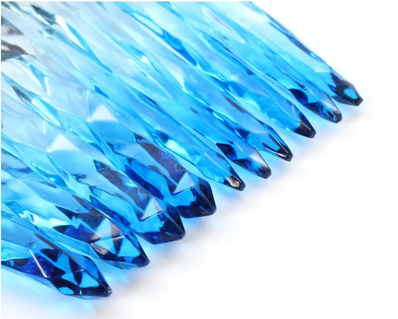 Ten clear crystal-handled foundation brushes with black synthetic bristles laid out on a surface.