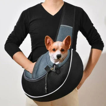 A stylish and secure crossbody bag designed to carry pets comfortably on the go, featuring adjustable drawstring closure and bottom zipper for easy access.