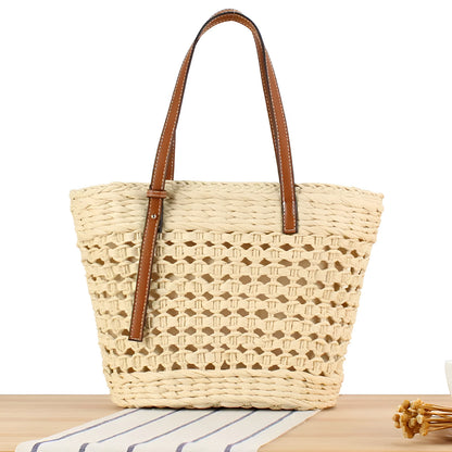 Beige woven paper-string shoulder bag with horizontal square shape and adjustable strap