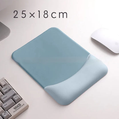 Square cloth mouse pad with grey silicone gel wrist rest and hand pillow on a wooden desk.