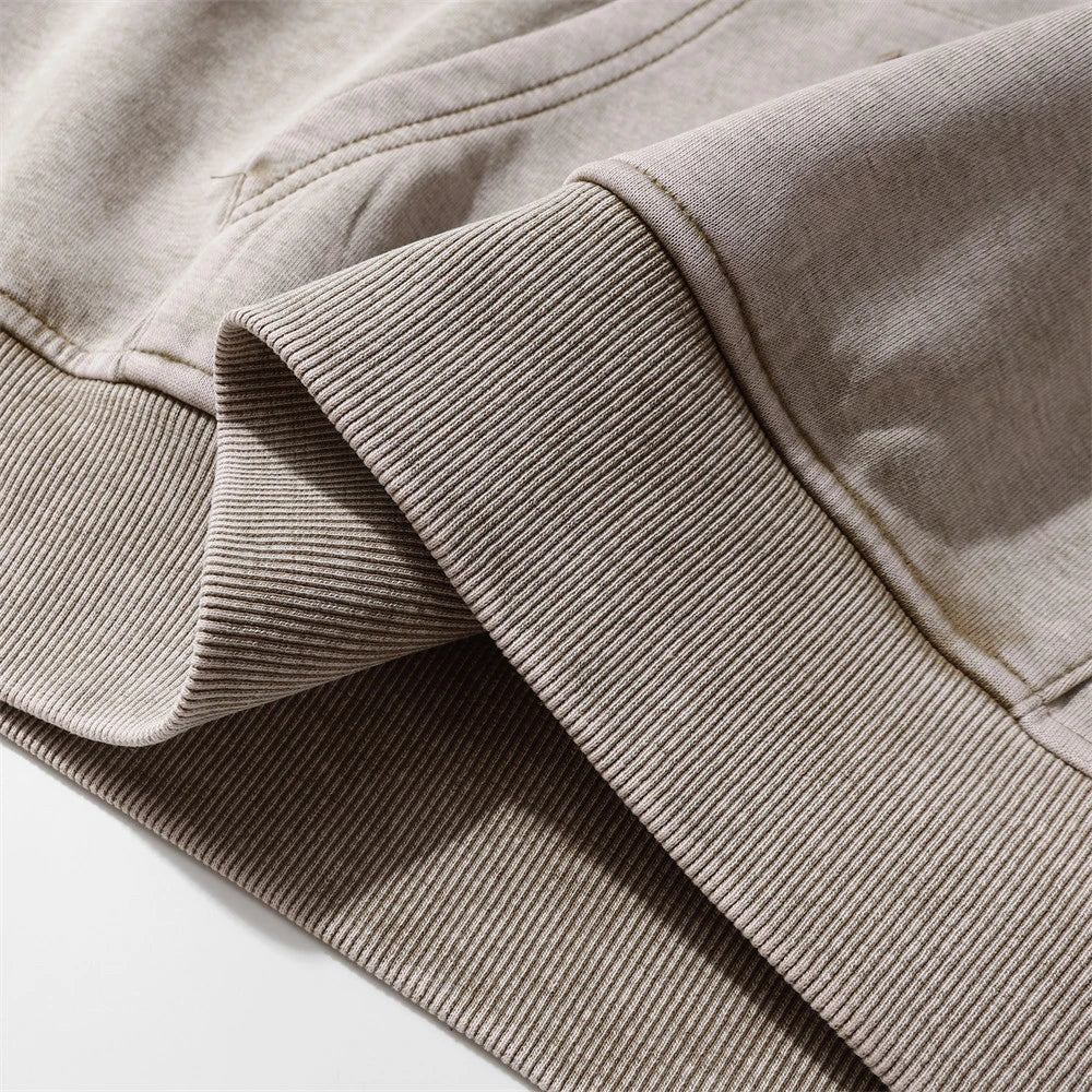 A brown cotton pullover hoodie with an embroidered letter patch design, perfect for casual and comfortable fall fashion.