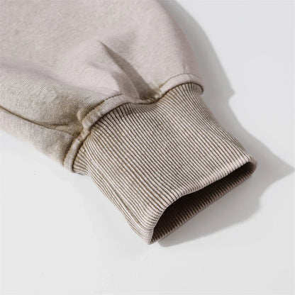 A brown cotton pullover hoodie with an embroidered letter patch design, perfect for casual and comfortable fall fashion.