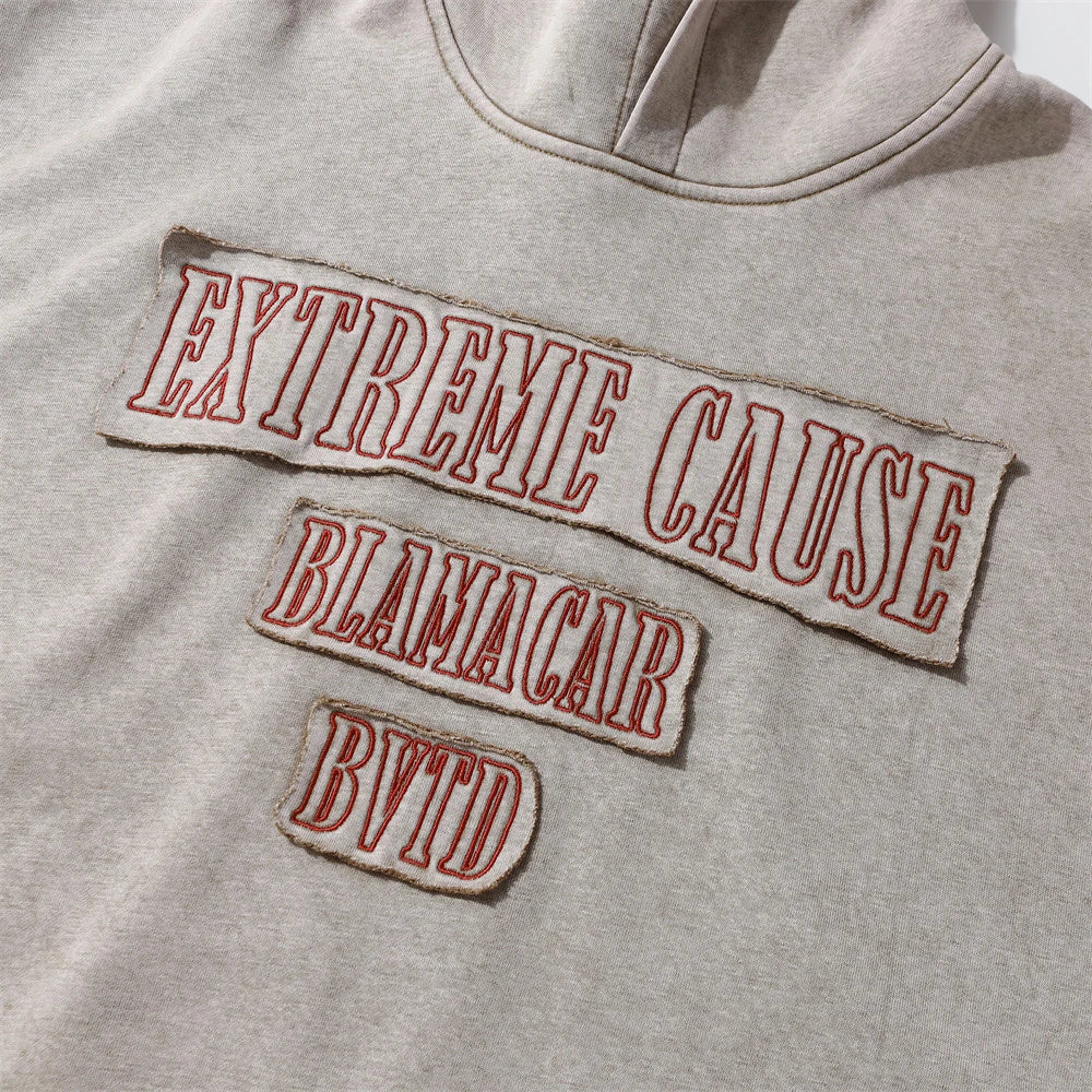 A brown cotton pullover hoodie with an embroidered letter patch design, perfect for casual and comfortable fall fashion.