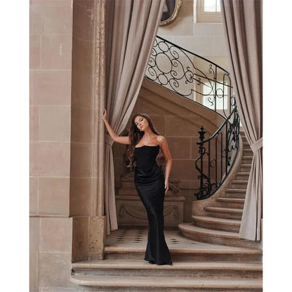 Elegant black strapless backless maxi dress for women, featuring a sleek bodycon silhouette and ankle-length sophistication.