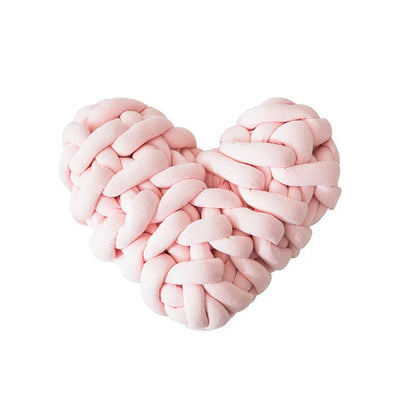 Heart-shaped decorative knot cushion in light gray color, fluffy and textured for cozy home decor