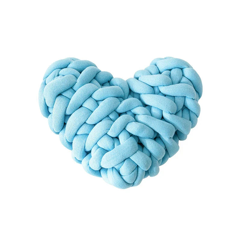 Heart-shaped decorative knot cushion in light gray color, fluffy and textured for cozy home decor