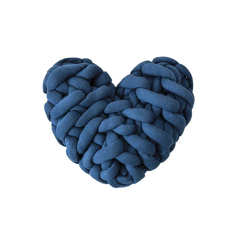 Heart-shaped decorative knot cushion in light gray color, fluffy and textured for cozy home decor