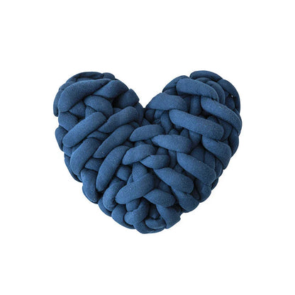 Heart-shaped decorative knot cushion in light gray color, fluffy and textured for cozy home decor