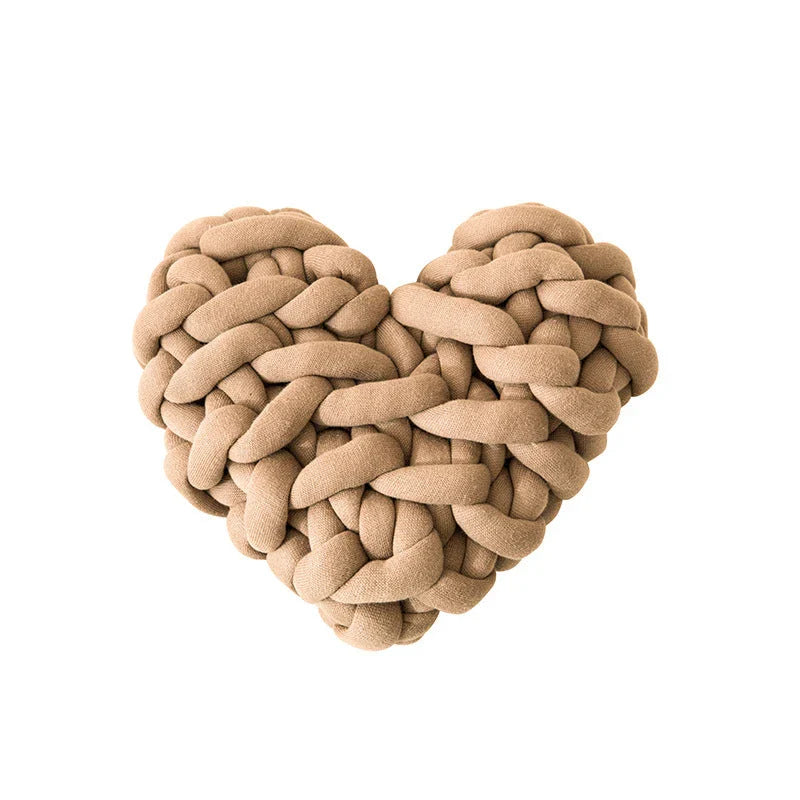 Heart-shaped decorative knot cushion in light gray color, fluffy and textured for cozy home decor