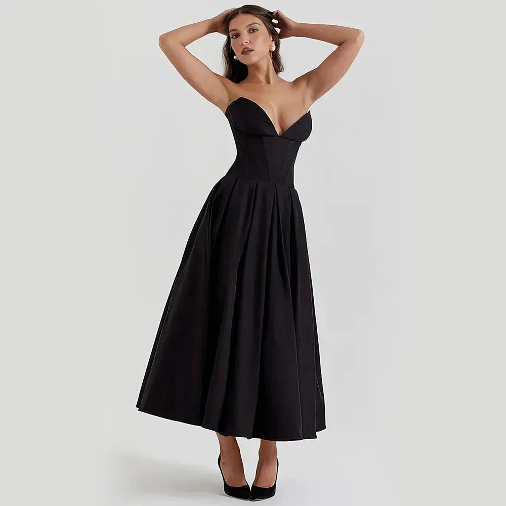 Elegant black maxi dress with spaghetti straps and backless design, perfect for formal occasions and turning heads