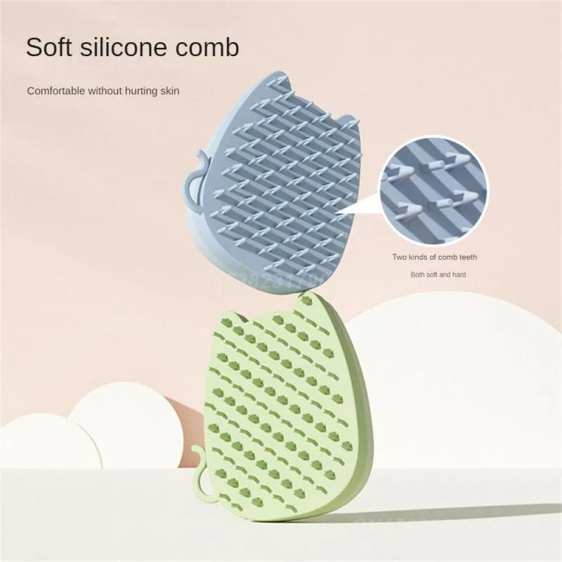 Blue silicone and sponge pet grooming brush with dual comb teeth on a wooden surface.