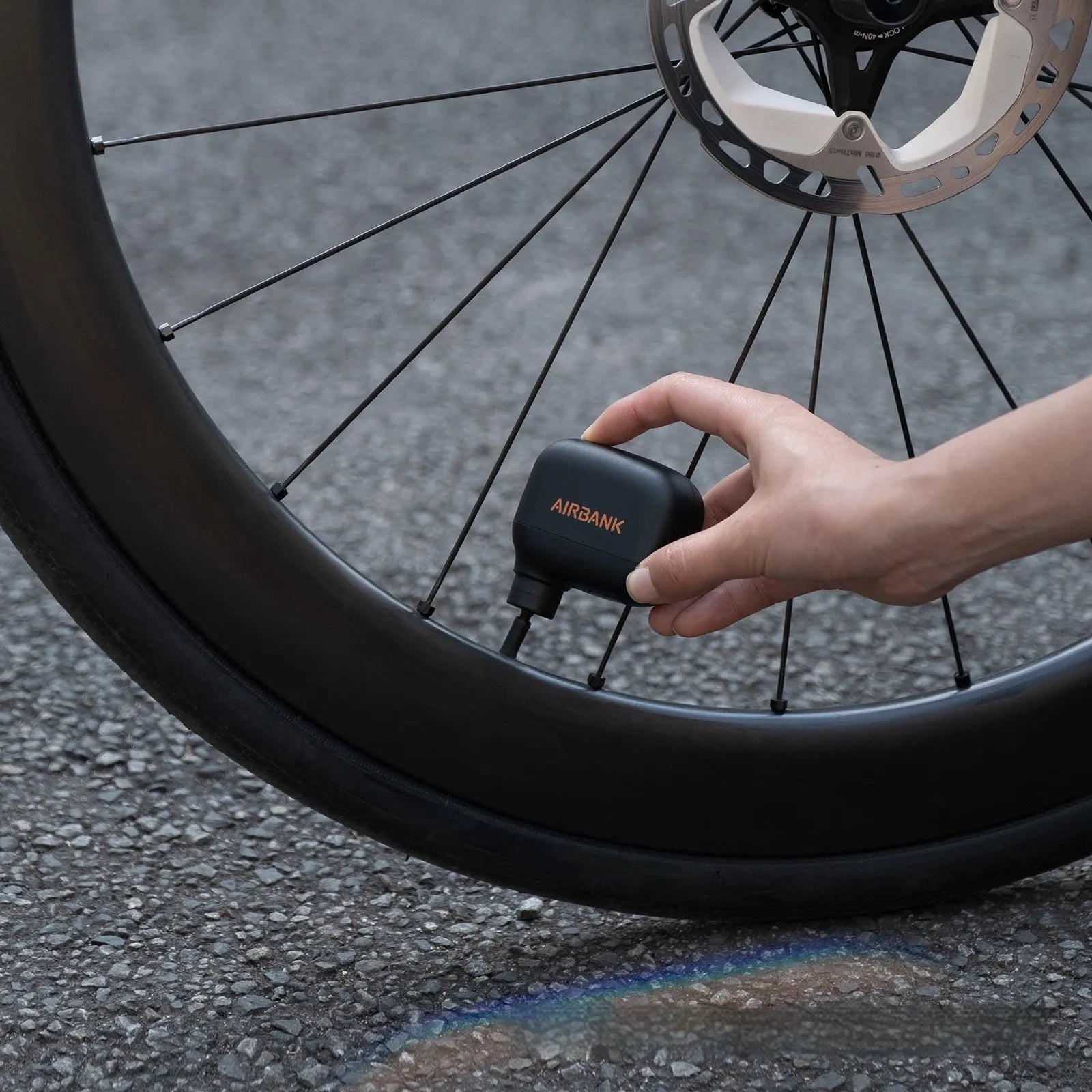 Black AS100 portable electric bike tyre inflator with USB cable and waterproof bag