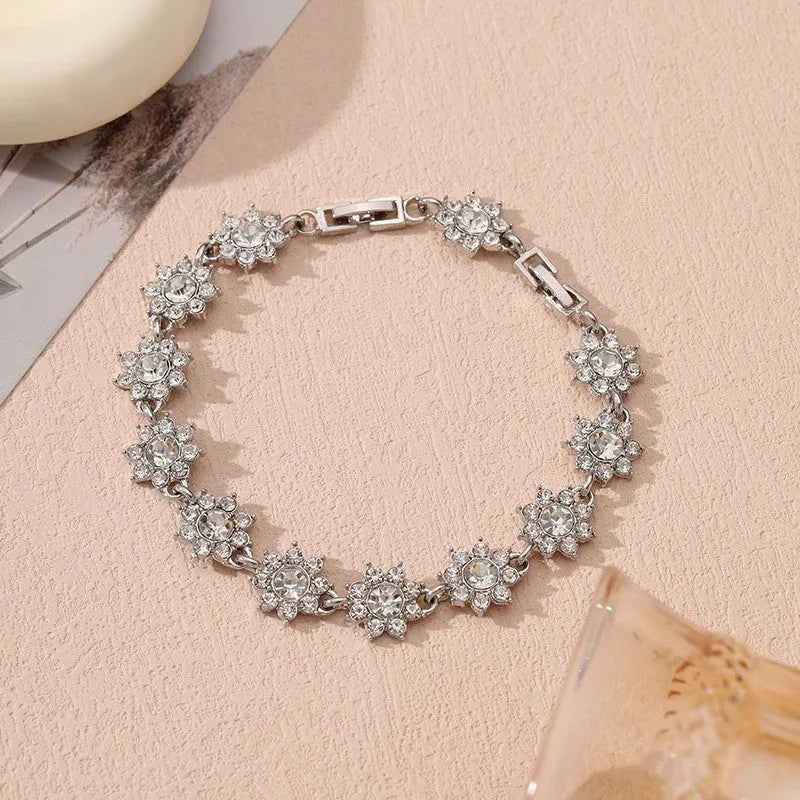 Floral shaped zinc alloy bracelet with electroplated colourful gem finishes in gold and silver tones.