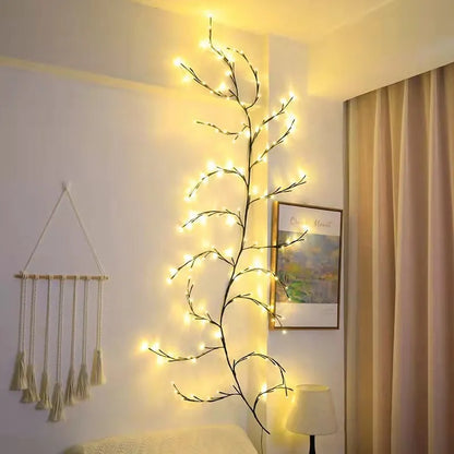 Flexible DIY willow vine LED light garland with warm white lights shaped on a wall.
