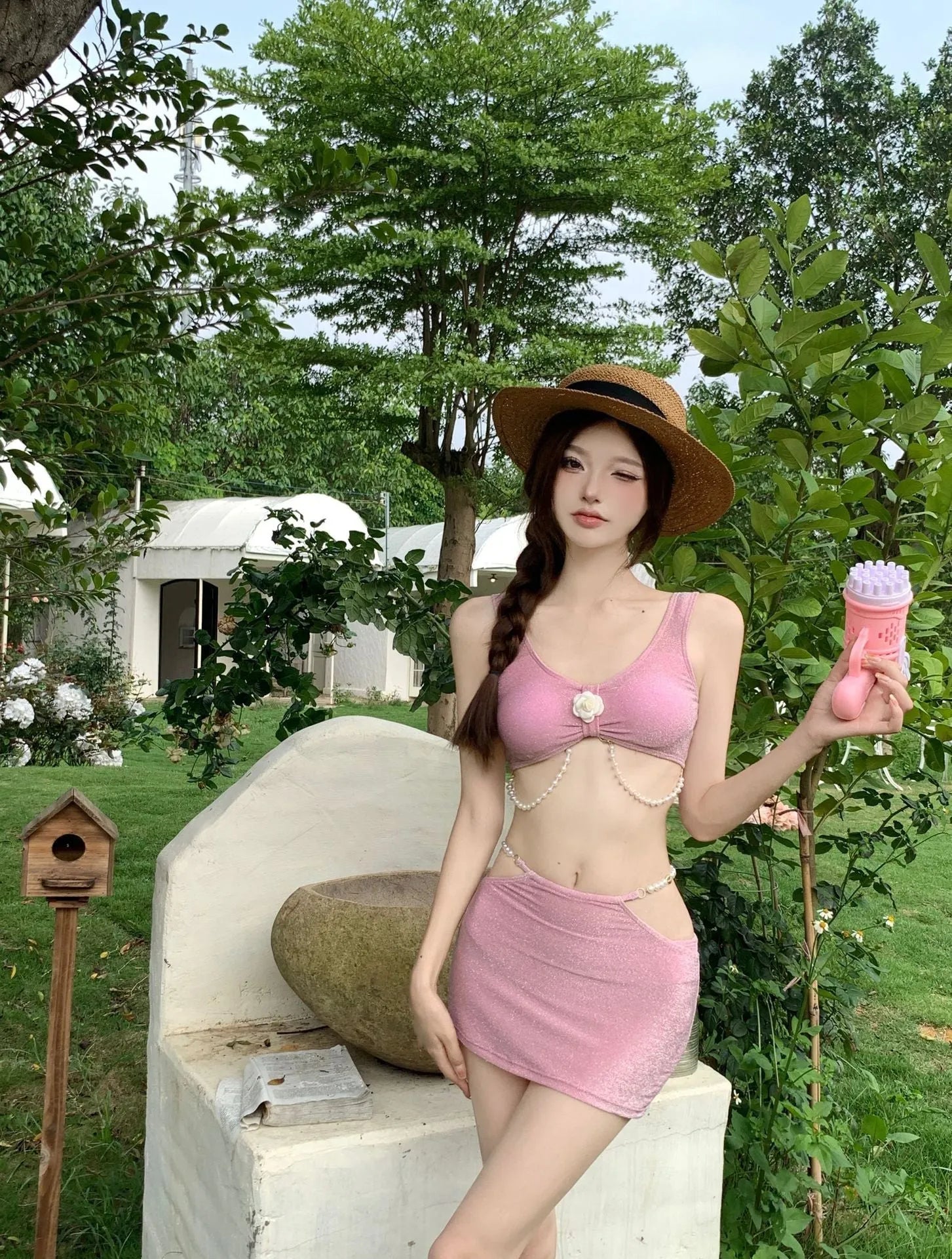 Pink and black three-piece bikini set with briefs style and sleeveless design for swimming.
