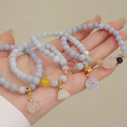 Gold plated women's bracelet with artificial crystal aquamarine chalcedony pendant in climbing cat design