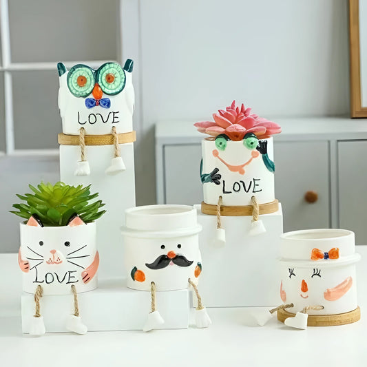Ceramic hanging foot flowerpot for succulent plants with cartoon styling on desktop