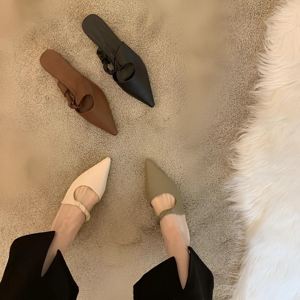 Women's soft leather slippers with semi-toe box in black, khaki, cream-white, and dark brown colours on a rubber sole.