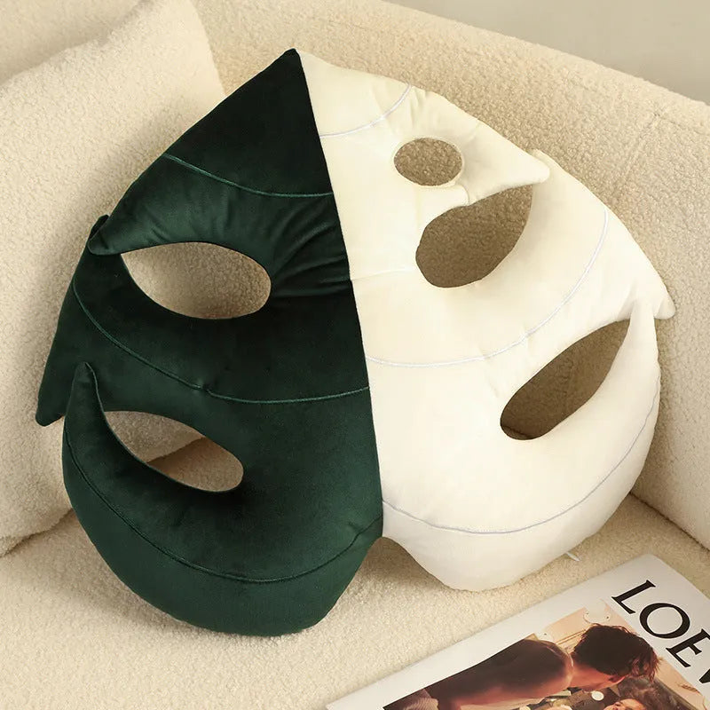 Green embroidered plant cushion with monstera leaf pattern on plush fabric
